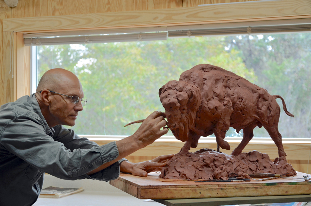 sculptor with buffalo